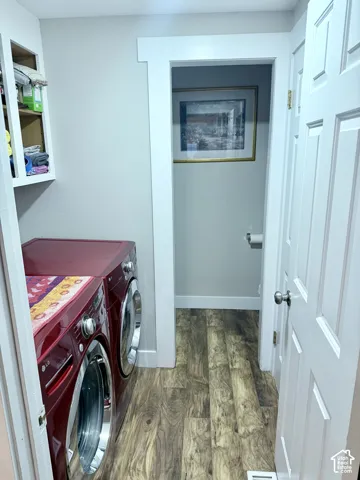 Wood-finish flooring throughout, complemented by a white paneled door