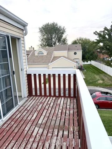 Private balcony featuring sliding glass doors and wood decking