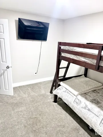 Light gray wall paint, light gray carpet, and a white interior door