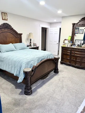 Recessed lighting, light gray carpet, and white trim molding