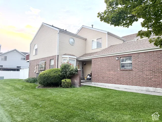 Exterior featuring brick and horizontal siding, a bay window, and a circular accent window