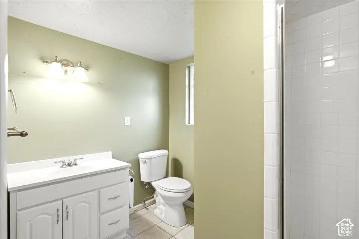 White vanity with cabinet storage, integrated sink, and brushed nickel faucet