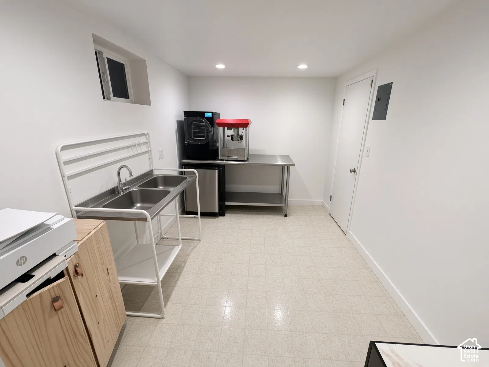 White walls, recessed lighting, and light-toned flooring