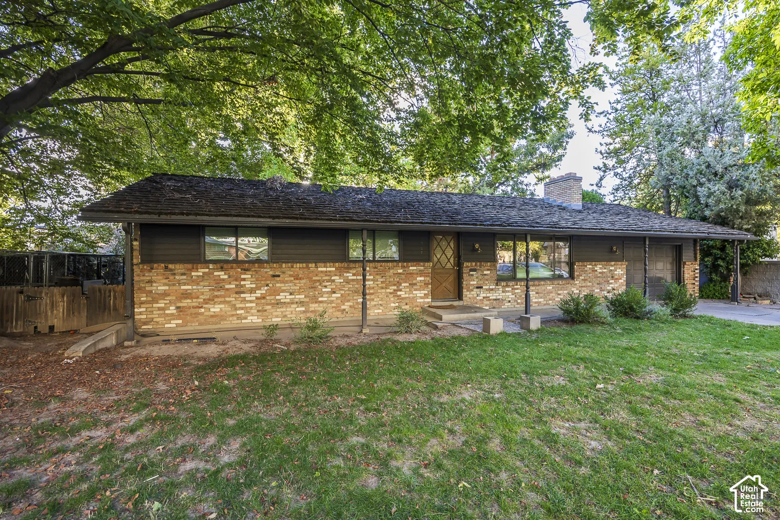 Brick and siding exterior with mature trees