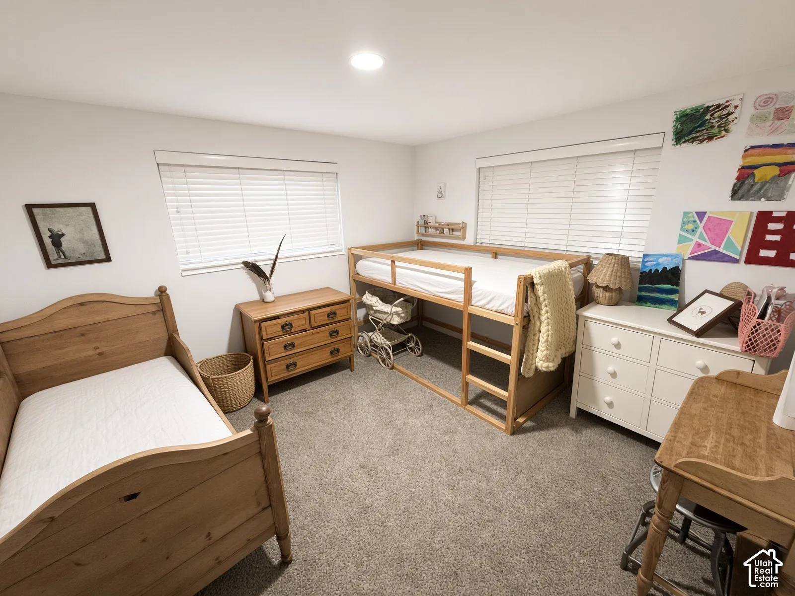 Recessed ceiling lighting, light-toned carpeting, white walls, and two windows with blinds