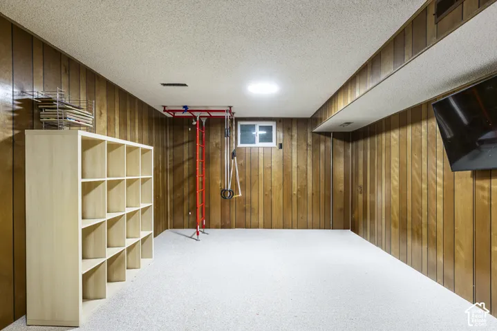 Wood paneling throughout, recessed lighting, and a window for natural light