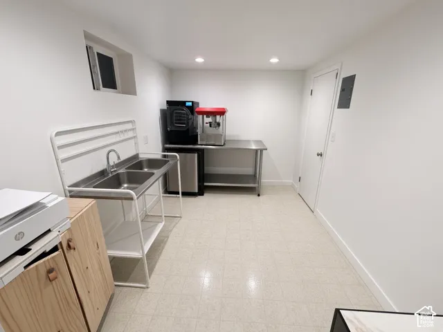White walls, recessed lighting, and light-toned flooring