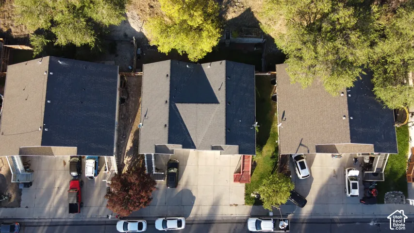 Aerial perspective featuring three multi-level structures with asphalt shingle roofs and concrete driveways