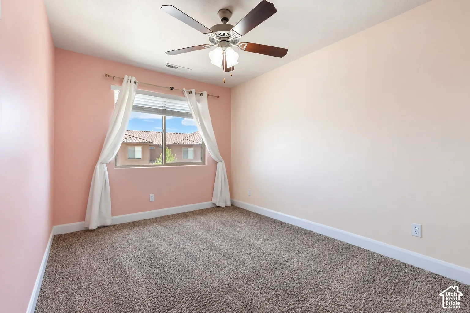 Textured carpeting and a ceiling fan with light fixture