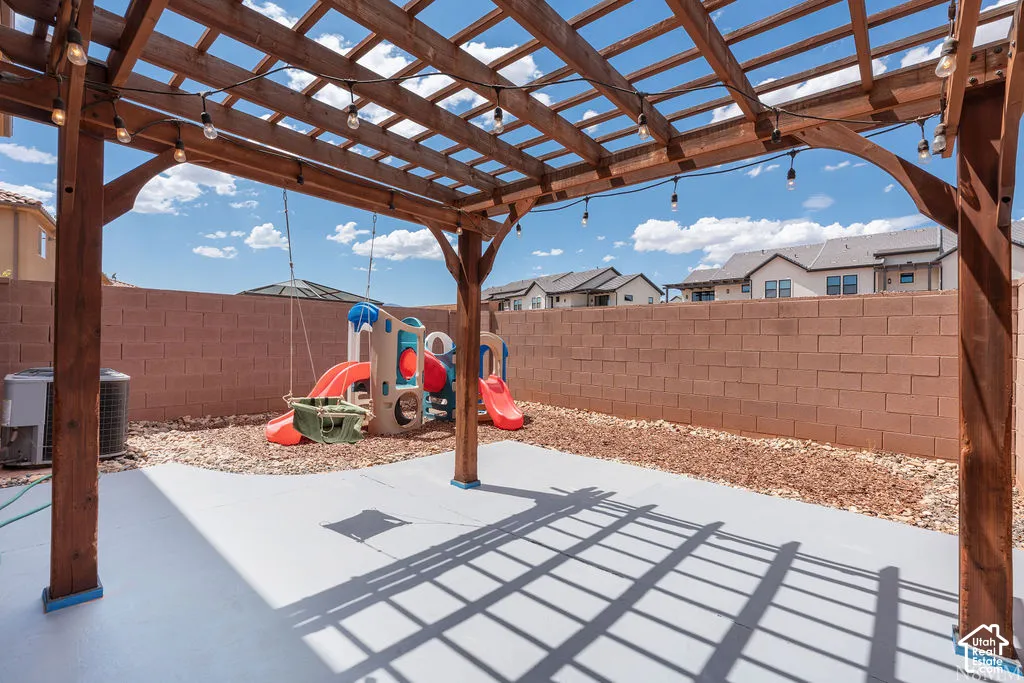 Outdoor pergola with string lighting over a concrete patio