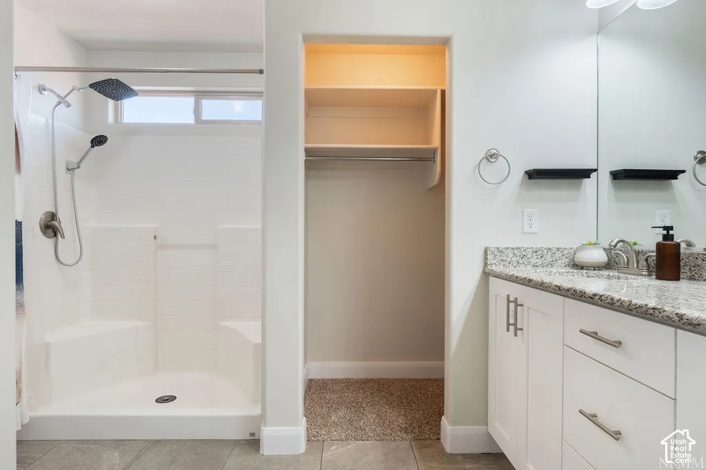 Walk-in shower with built-in bench seating and a transom window