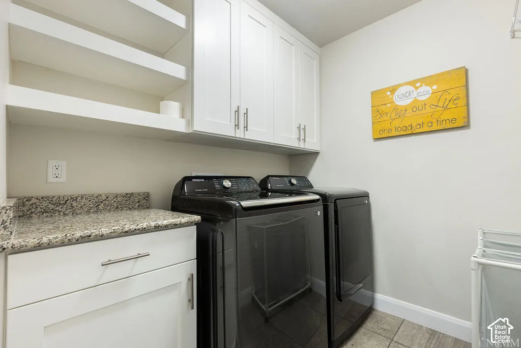 White cabinetry with brushed nickel hardware, open shelving, and a granite-style countertop