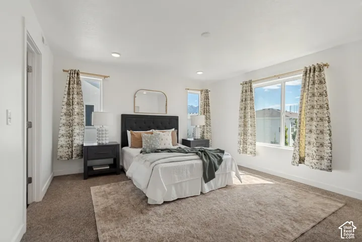 Recessed lighting, white walls, and broad windows