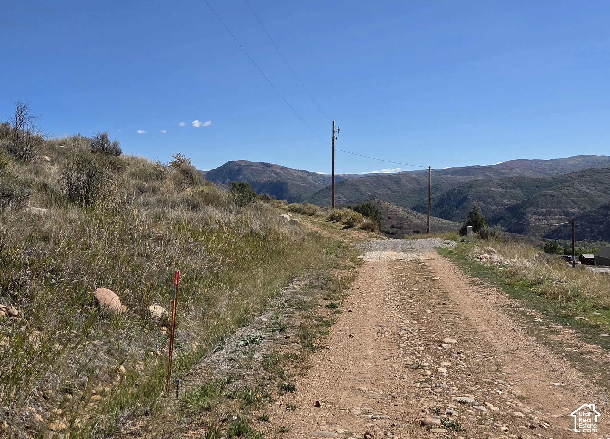 Gravel road access with surrounding mountainous terrain