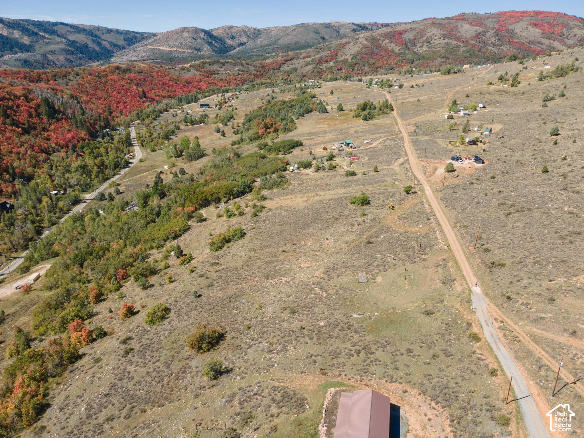 Expansive mountainous landscape with natural terrain and scattered trees