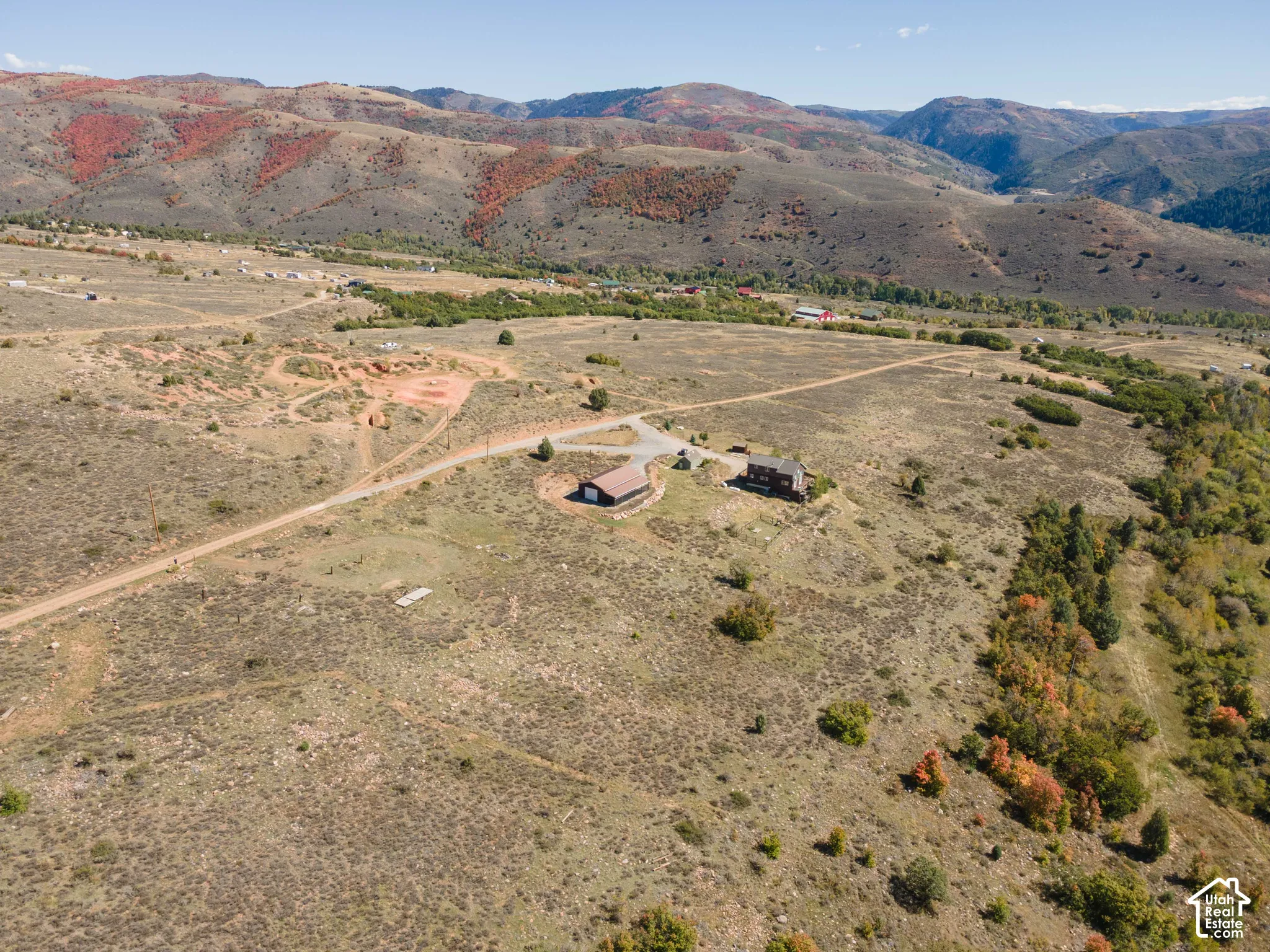 Expansive natural landscape featuring rolling hills and distant mountainous terrain