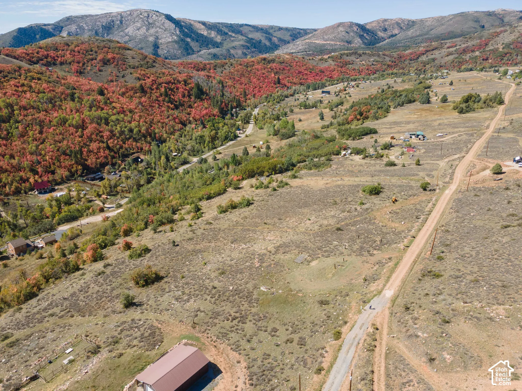 Rolling terrain with a visible road and distant mountainous backdrop