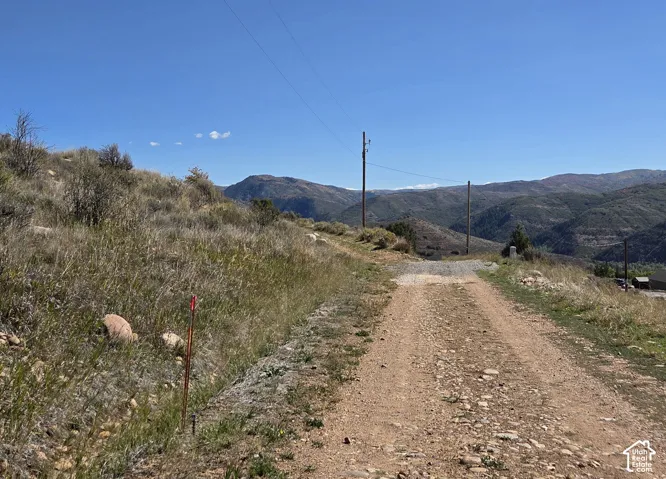 Gravel road access with surrounding mountainous terrain