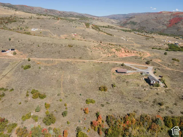 Expansive undeveloped land featuring natural terrain and distant mountain ranges