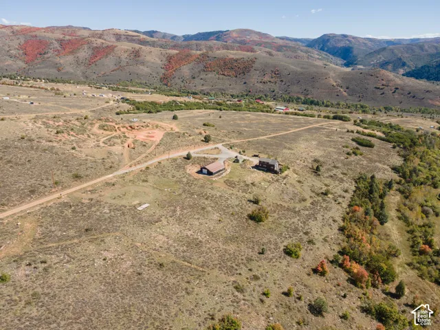 Expansive natural landscape featuring rolling hills and distant mountainous terrain