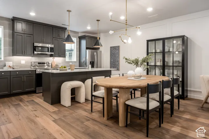 Kitchen with dark cabinetry, stainless steel appliances, and a central island