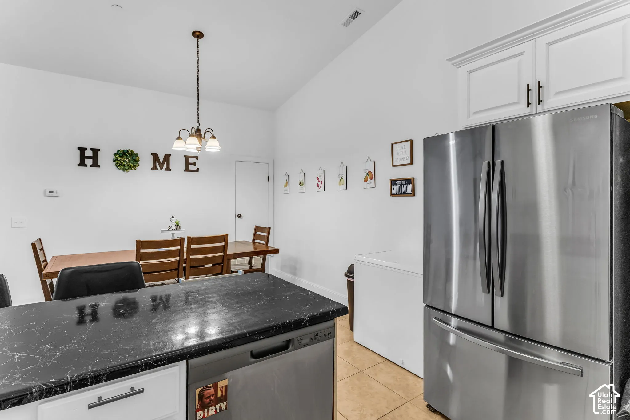 Vaulted ceiling dining area with a chandelier