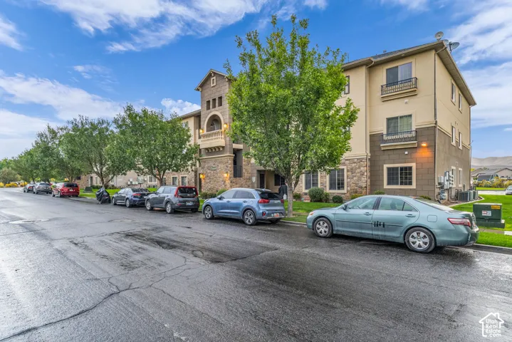 Multi-level exterior featuring stone accents, stucco siding, and multiple balconies