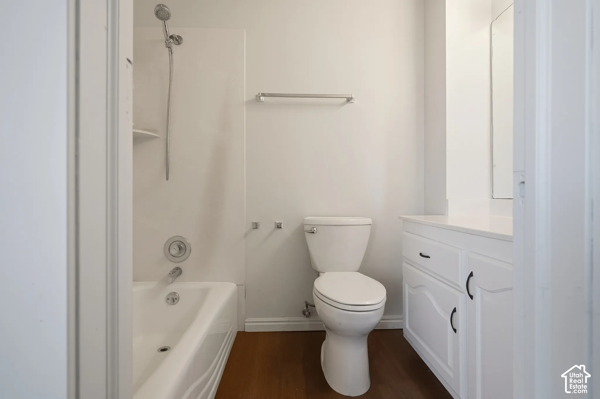 White vanity with dark hardware, white countertop, and integrated sink