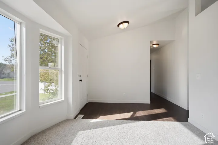 Bright interior with multiple windows and a front entry door