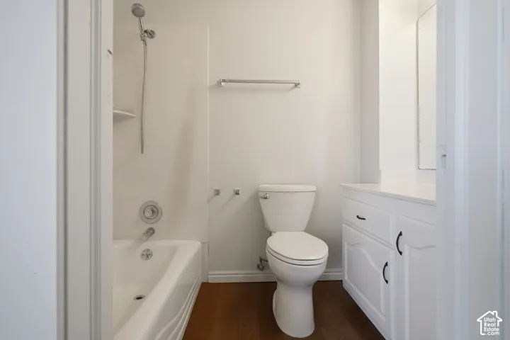 White vanity with dark hardware, white countertop, and integrated sink