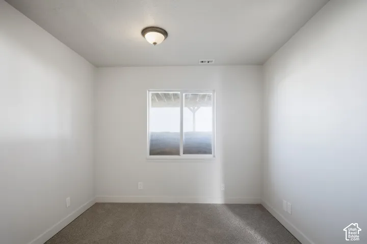 Carpeted flooring, single window, flush-mount ceiling light fixture, white walls