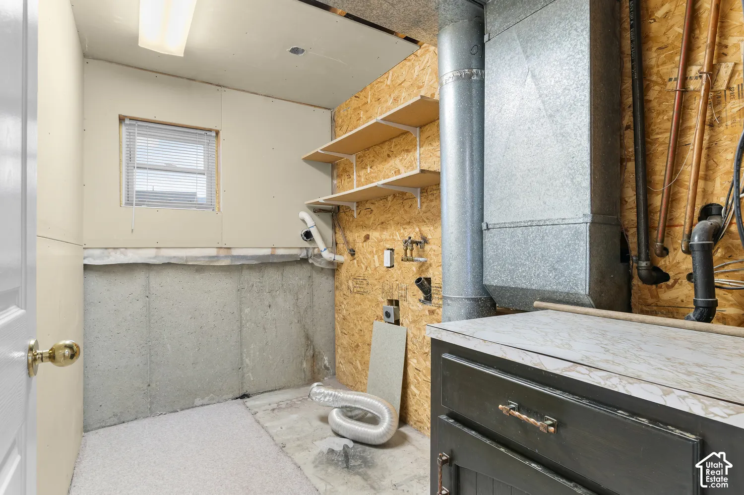 Laundry room with cabinet and window