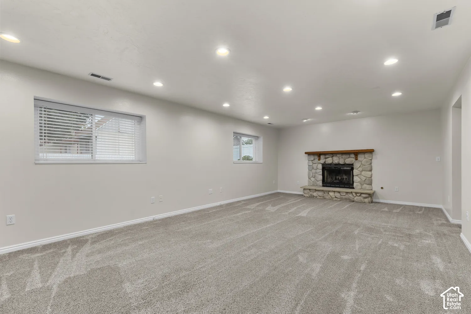 Large living room with fireplace and newer carpet