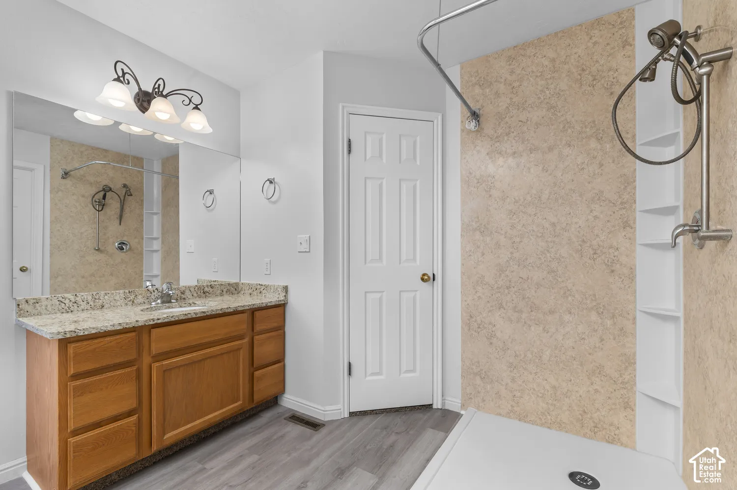 Primary Suite bath with granite countertops and curbless shower