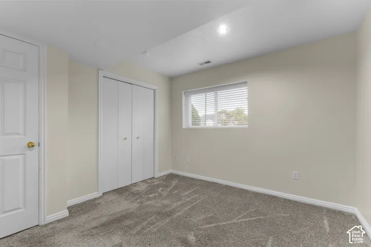 Neutral-toned walls complement the carpeted flooring