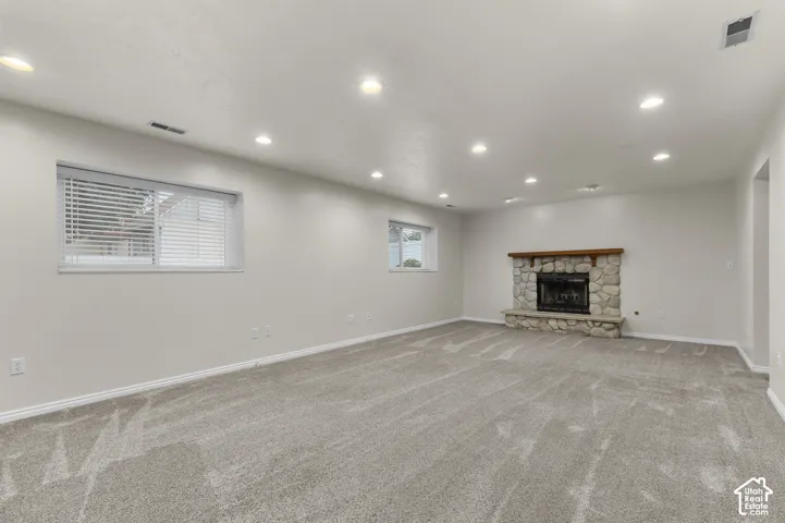 Large living room with fireplace and newer carpet