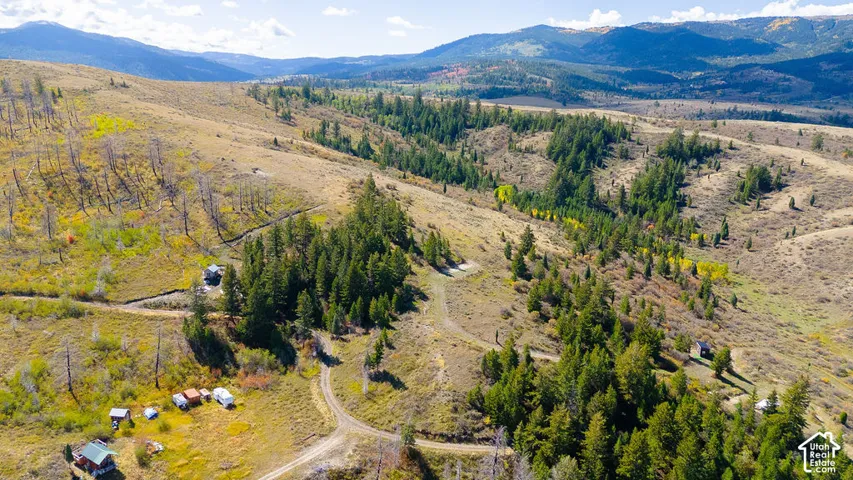 Expansive terrain with varied topography, including wooded areas and open fields