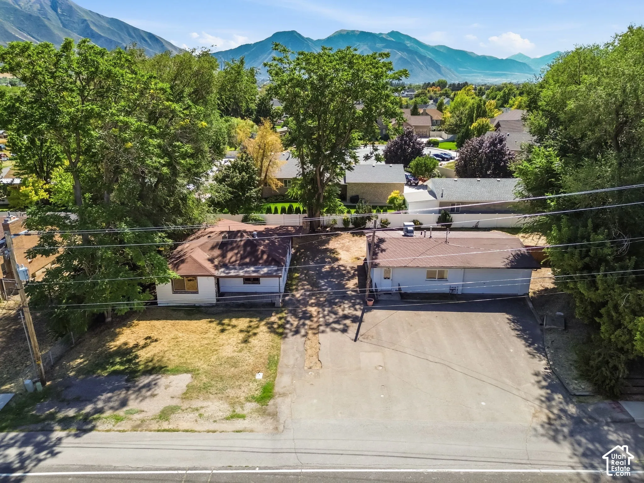 Properties featuring mountain scenery, mature trees, and a paved street