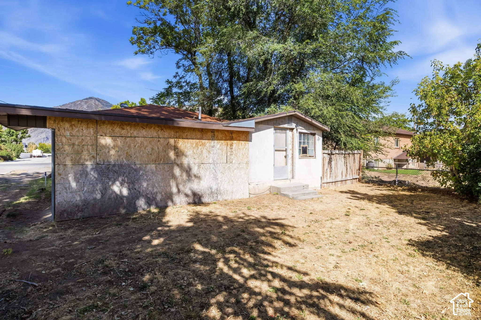 view of carport and back door that leads to laundry room
