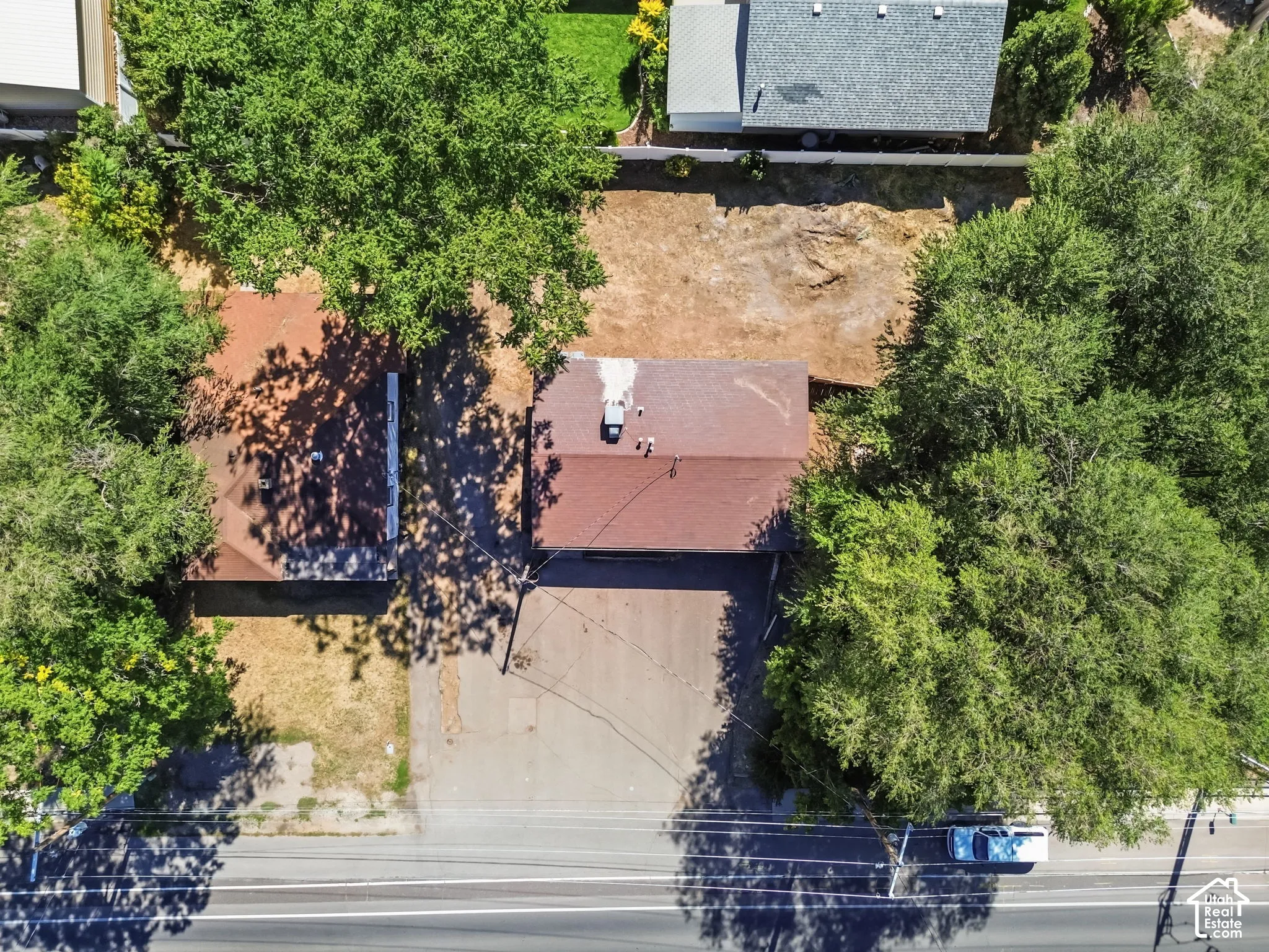 aerial view of front of detached building, home on the left