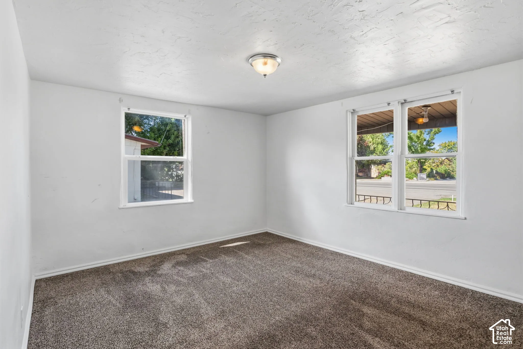 Neutral wall tones with textured ceilings and carpet flooring