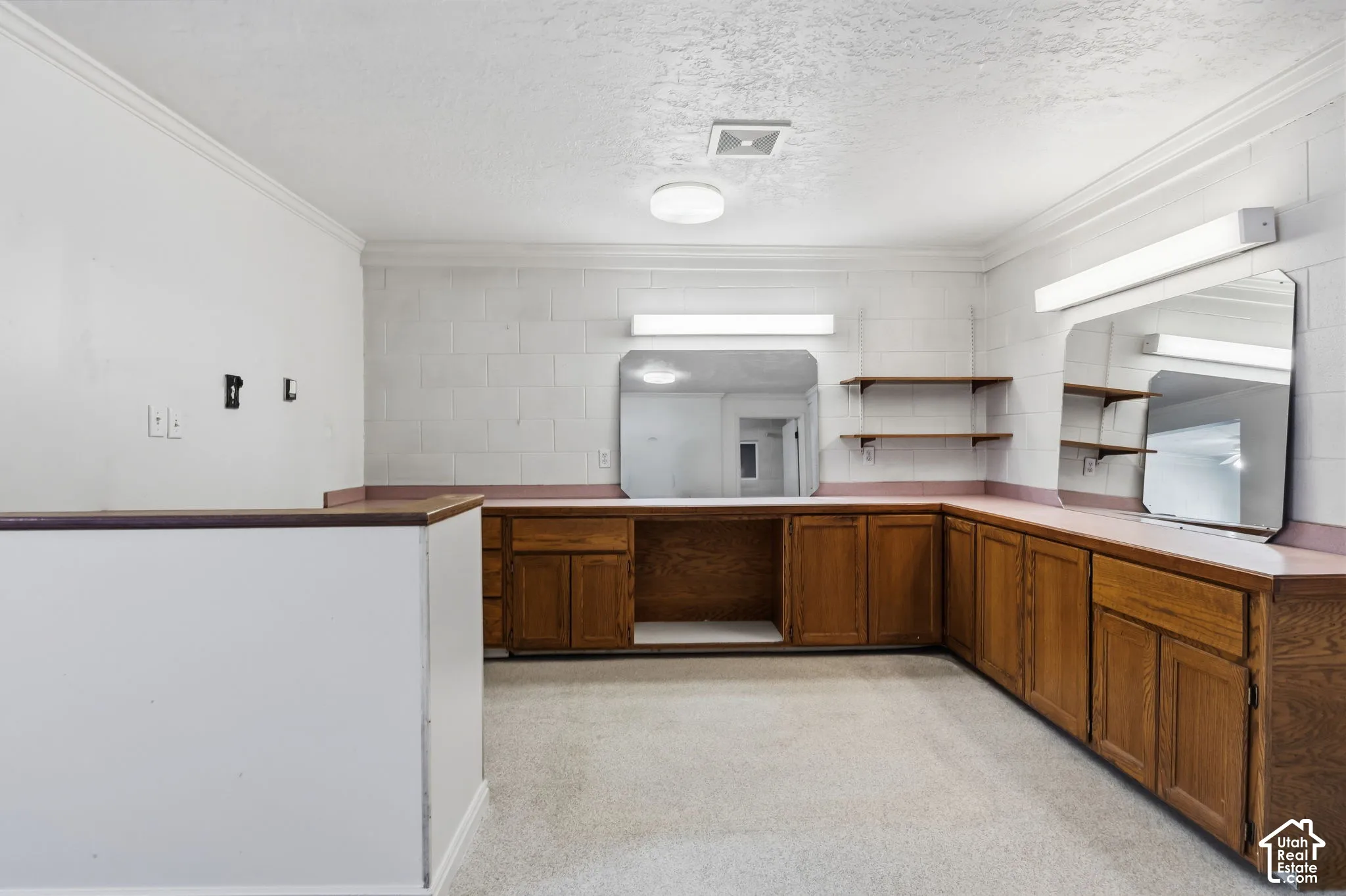 front desk at left, built in cabinets and mirrors