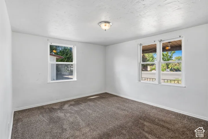 Neutral wall tones with textured ceilings and carpet flooring