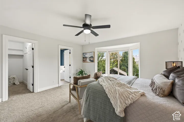 Recessed bay window, ceiling fan with integrated lighting, two panel interior doors, and carpeted flooring