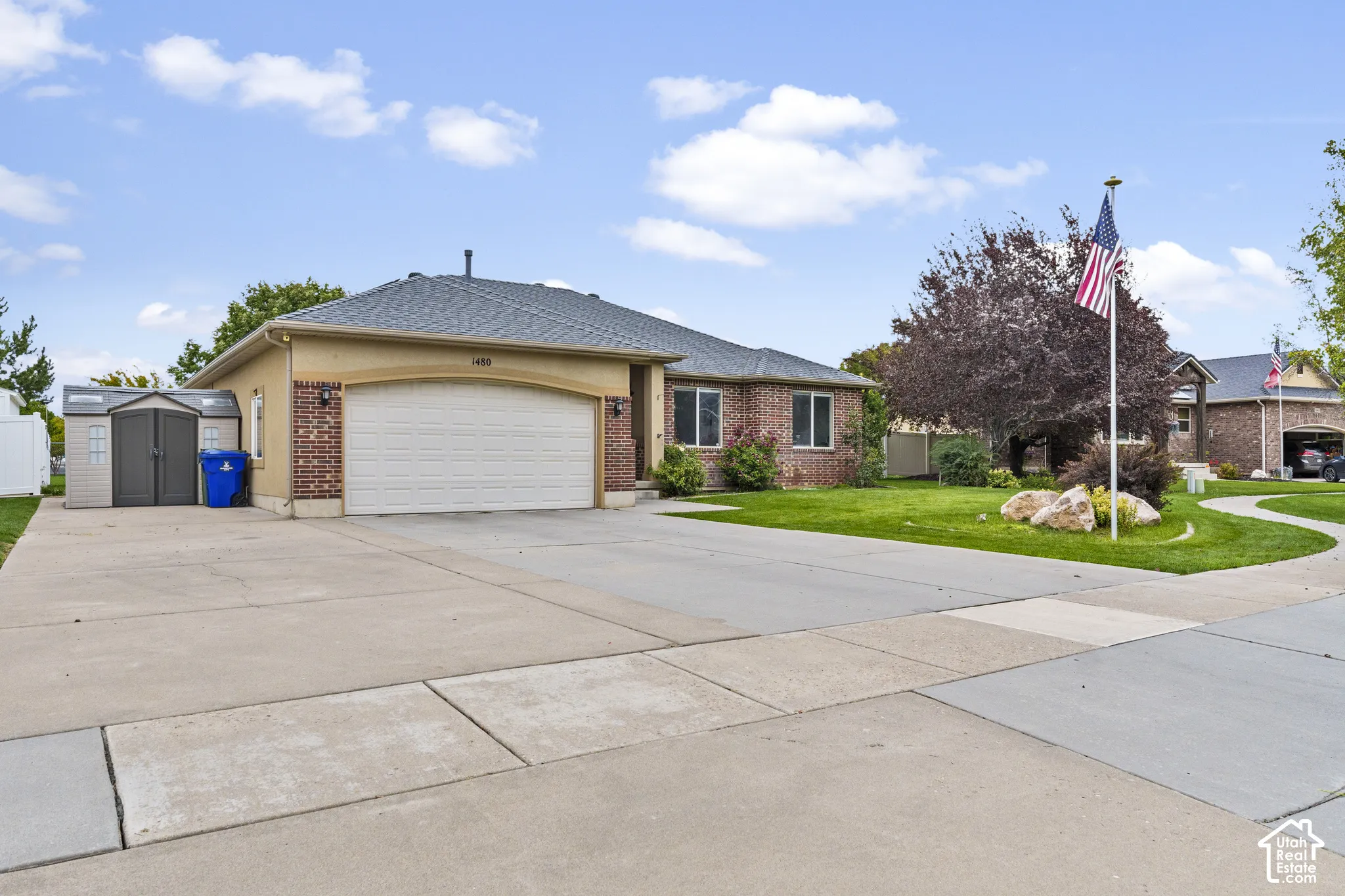 Brick and stucco exterior with an attached garage