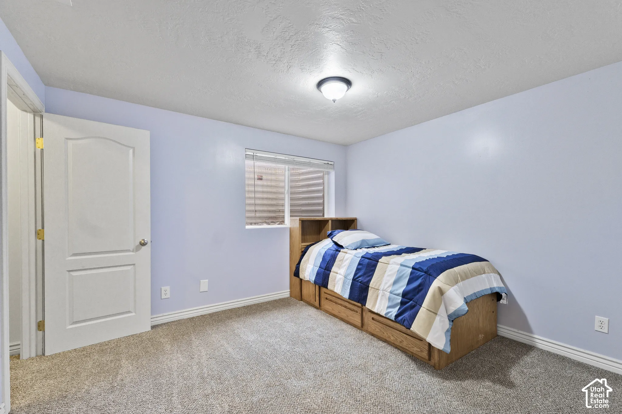 Recessed window, ceiling-mounted light fixture, light grey wall finish, and new carpet and paint.