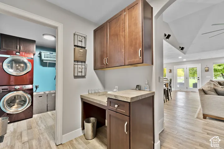Wood-finish flooring throughout, with a built-in desk and upper and lower cabinetry