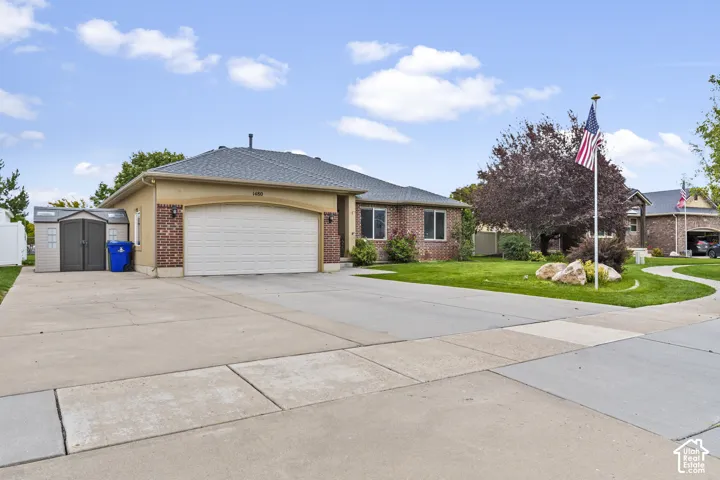 Brick and stucco exterior with an attached garage