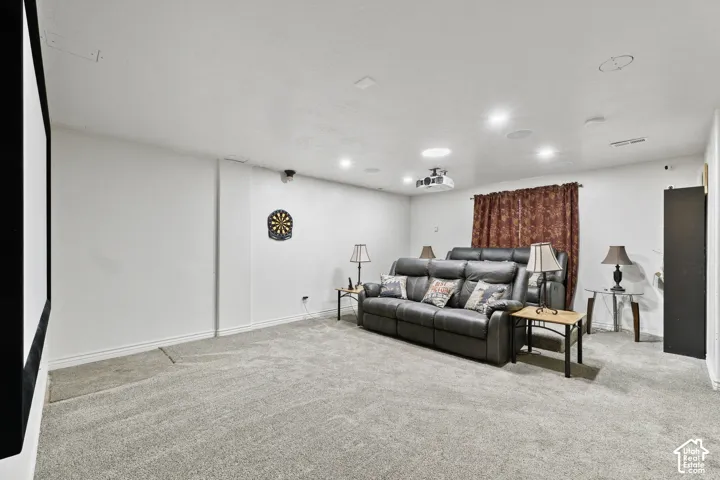 Integrated projector and screen, recessed lighting, wall-to-wall carpeting, window with drapery, ceiling-mounted speakers