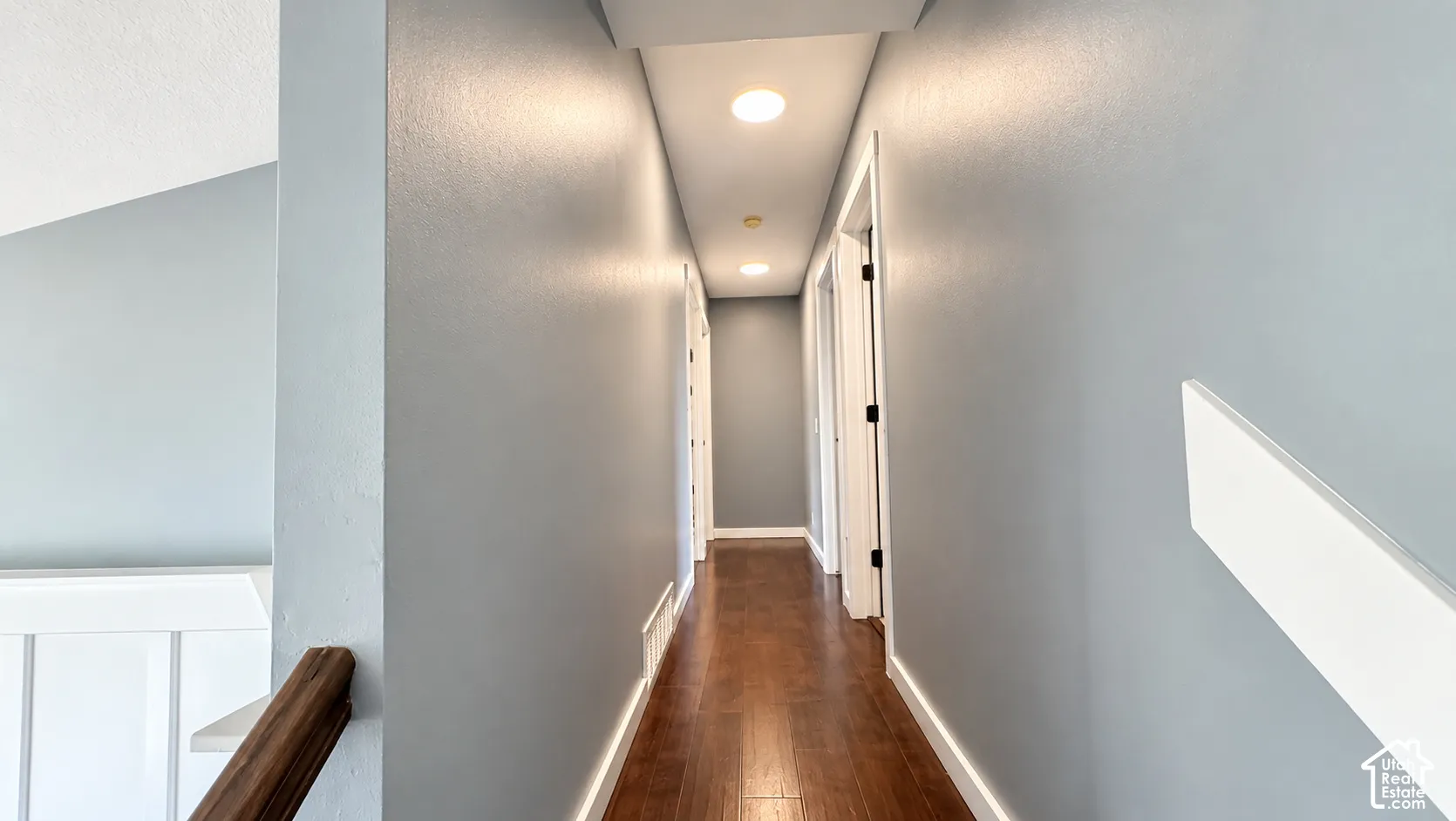 Wood-finish flooring, recessed lighting, painted walls, and white trim accents